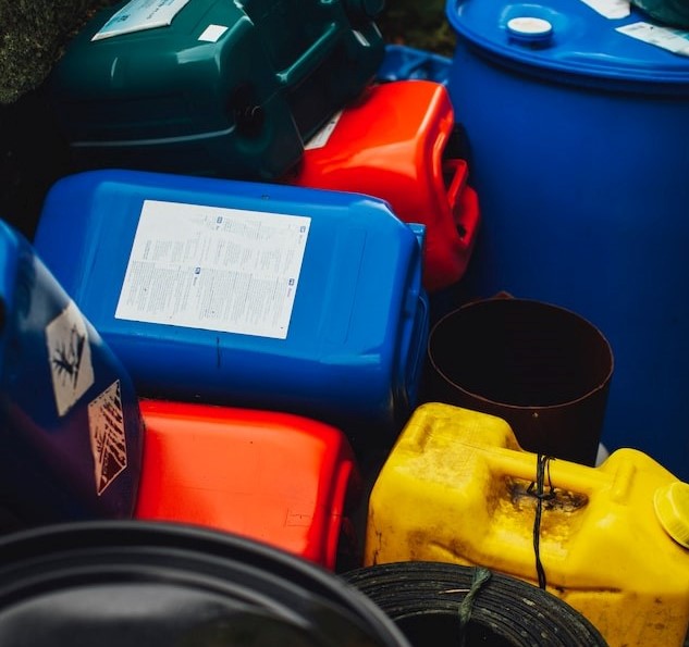 Close-up picture of dark green, blue, red and yellow plastic containers.